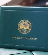 University of Oregon diploma covers lined up on a table