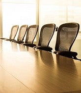 Empty board room table with chairs